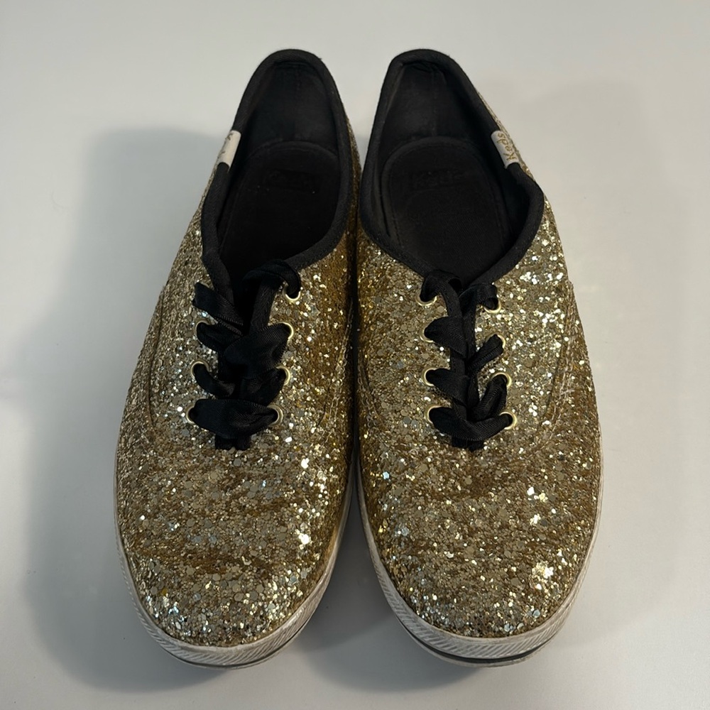 Kate Spade women's black and gold glitter sneakers